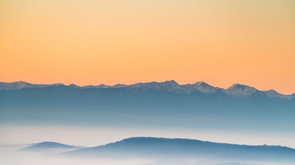 Misty mountain ridges at sunrise